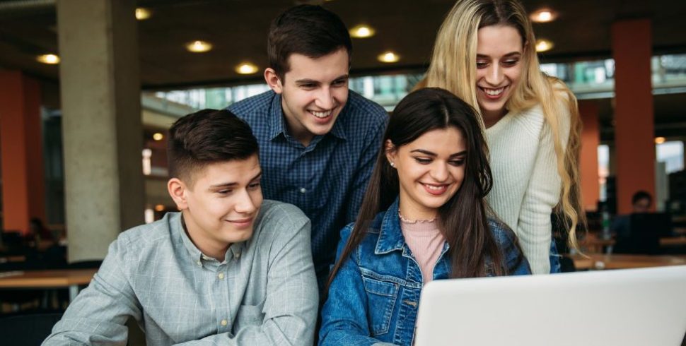 Group of college students using AI in a study group session
